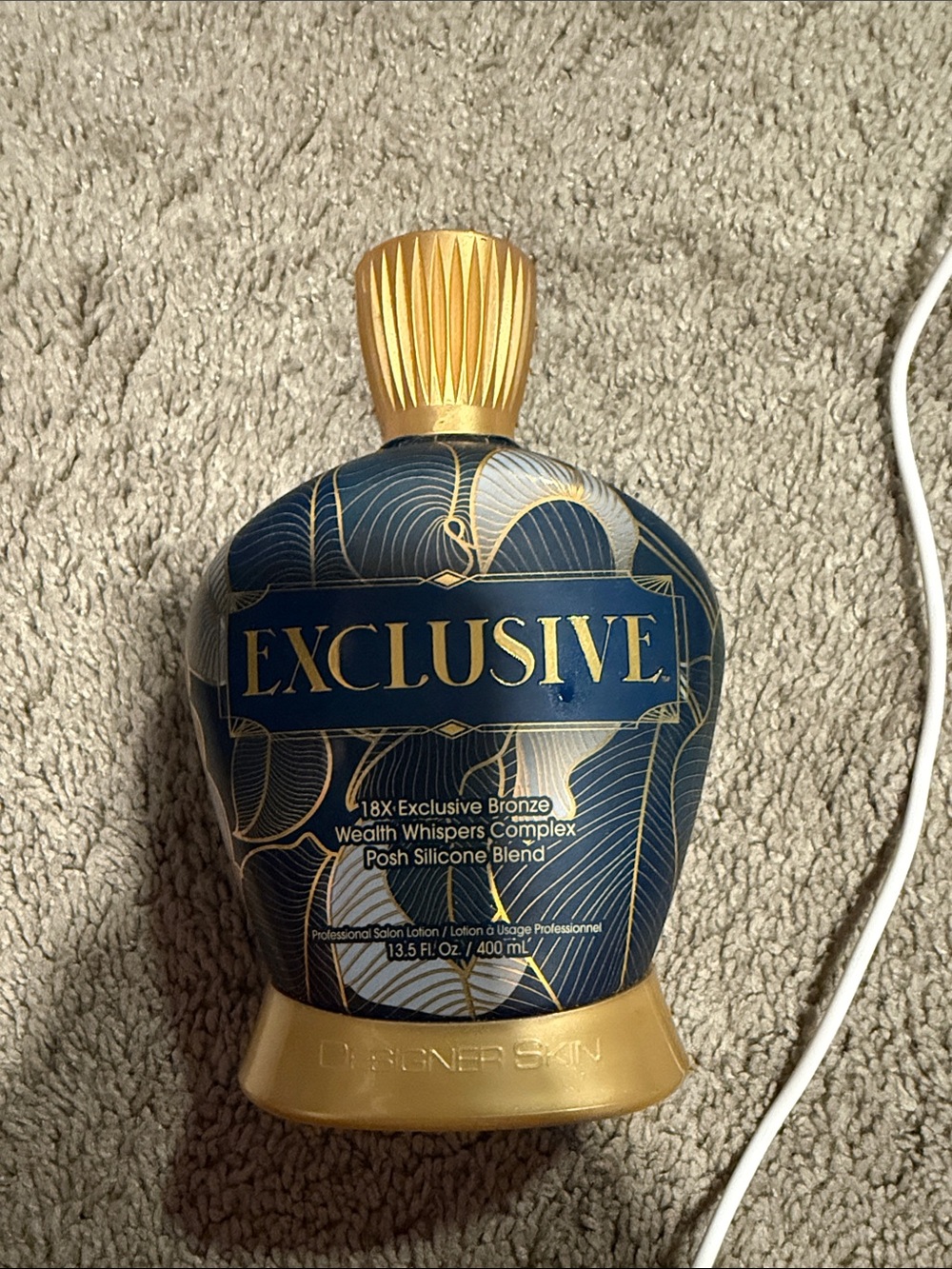 Exclusive 18X Bronze Tanning Lotion in Navy and Gold